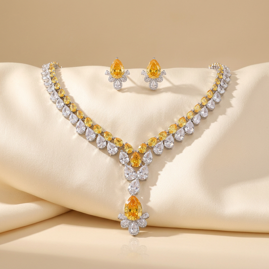 Two-tier drop necklace layering yellow and white cubic zirconia in silver-plated brass, with matching earrings