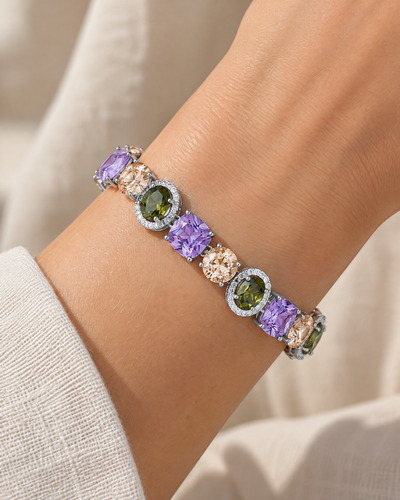 Wrist wearing the Purple Olive Multicolor Charm Bracelet, multicolour cubic zirconia in rhodium-plated settings
