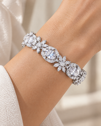 Wrist wearing the White Oval Tennis Bracelet, white cubic zirconia in rhodium-plated settings
