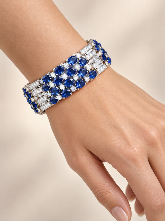 Royal Sapphire Oval Cluster Tennis Bracelet worn on the wrist, rhodium-plated with royal blue oval zirconia
